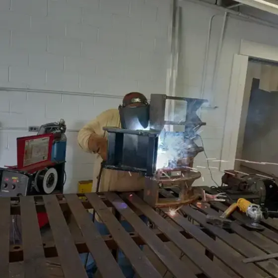 Welder fabricating a custom steel assembly
